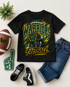 A black kids' short-sleeve T-shirt with a large 'WARRIORS FOOTBALL' graphic in green, yellow, and white, styled in a flat lay with a football, blue jeans, black sneakers, a green foam finger, and a small potted plant on a light beige background.