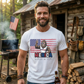 Man wearing a t-shirt with a graphic design in front of a cabin